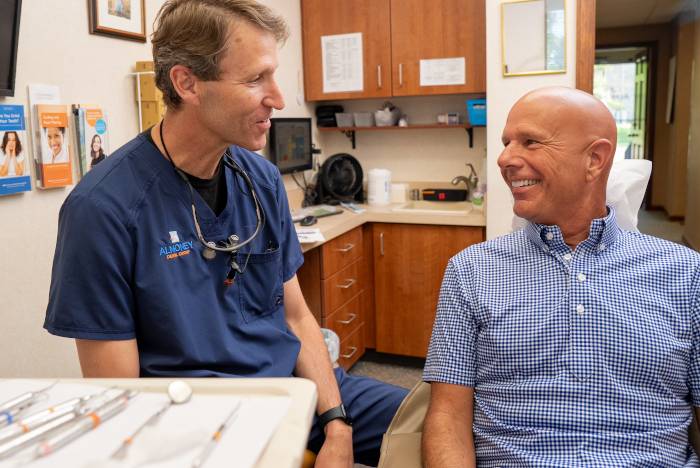 Dr. Almoney with a male patient at Almoney Dental Group in Dayton, OH