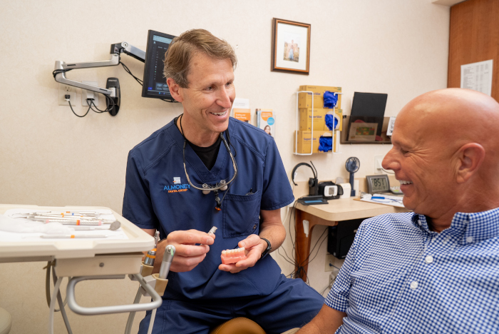 Dr. Almoney with a male dental patient at Almoney Dental Group in Dayton, OH