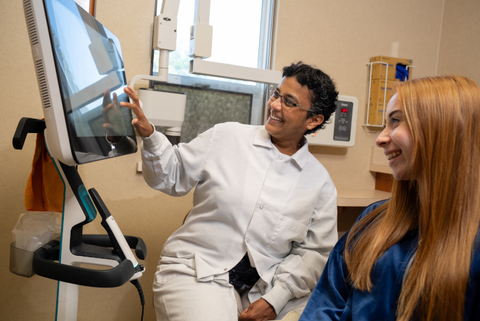 Dr. Manhu with a young female patient at Almoney Dental Group in Dayton, OH