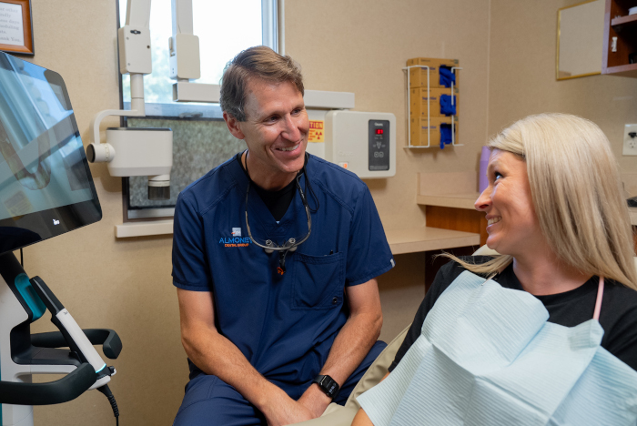Dr. William D. Almoney with a female patient having a conversation in a procedure room