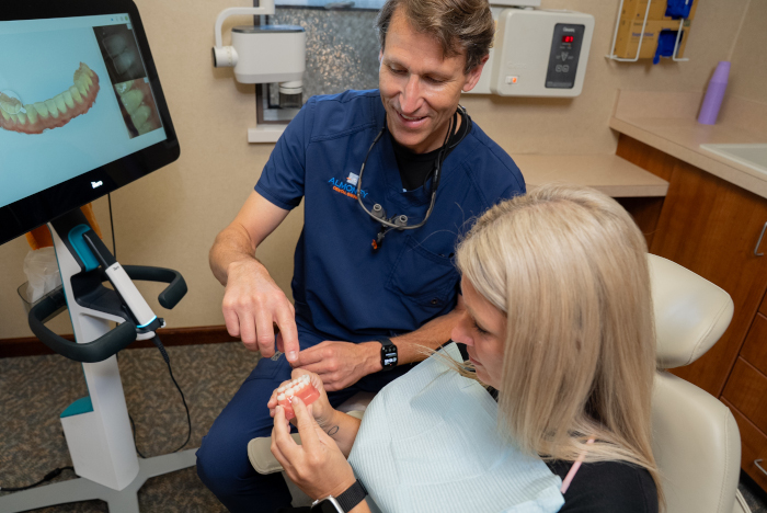 Doctor Almoney with a female patient explaining digital X-rays