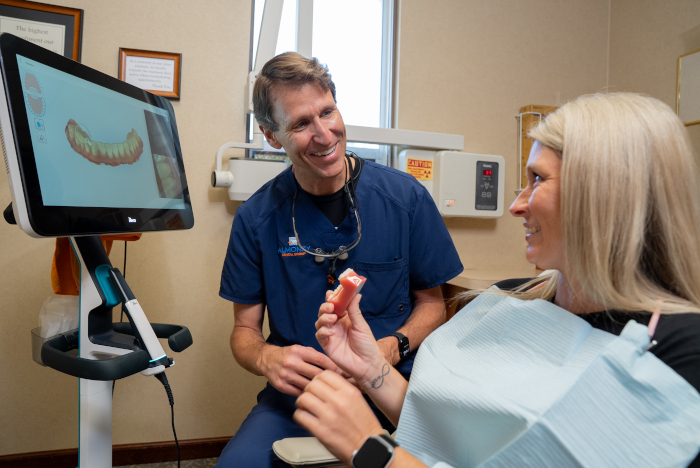 William D. Almoney, DDS with a female patient - Almoney Dental Group
