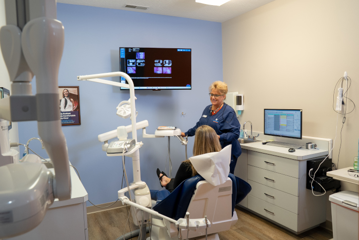 dental assistant with a patient in a dental chair at Almoney Dental Group