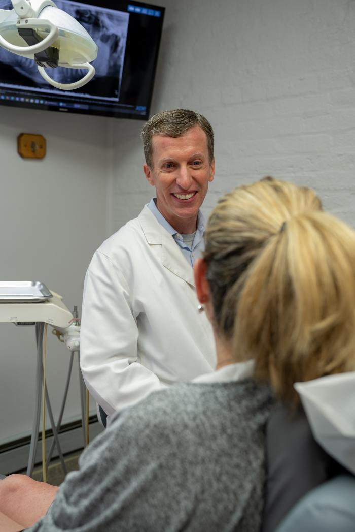 Gerald D. Brown, DDS consulting with a patient